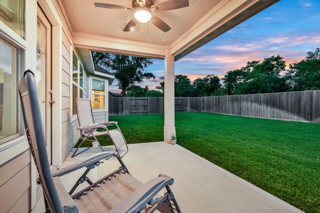 21310 Baldovin Way, Tomball, TX 77375 - patio terrace at dusk featuring ceiling fan, a fenced backyard, and a patio