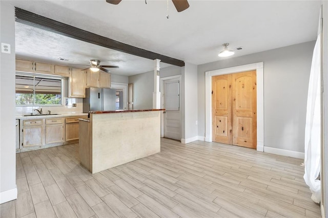 3520 Mattye Maye Dr, Pasadena, TX 77503 - kitchen with a ceiling fan, freestanding refrigerator, light brown cabinetry, a center island, and light wood finished floors