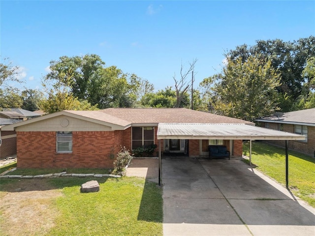 3520 Mattye Maye Dr, Pasadena, TX 77503 - ranch-style house featuring a front yard, an attached carport, concrete driveway, and brick siding