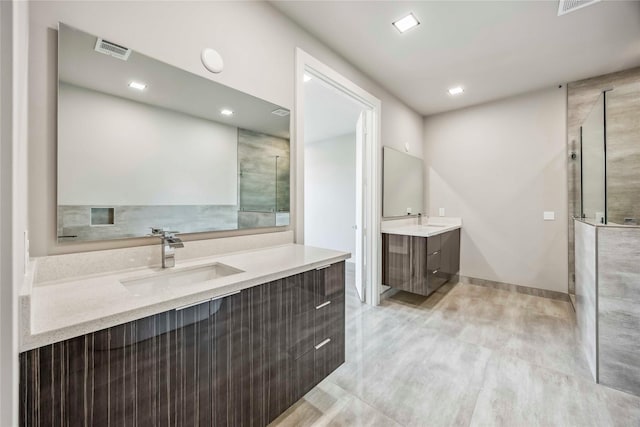 1111 W 21st St, Houston, TX 77008 - full bathroom with two vanities, a tile shower, and recessed lighting