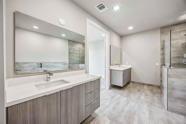 1111 W 21st St, Houston, TX 77008 - full bath with two vanities, a shower with door, and recessed lighting