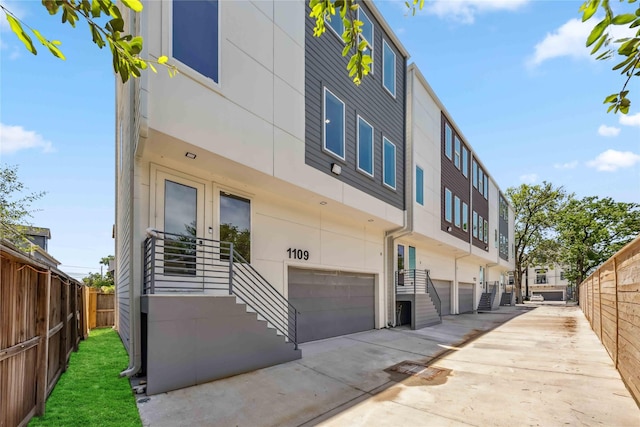 1111 W 21st St, Houston, TX 77008 - view of property with an attached garage, driveway, and stairway