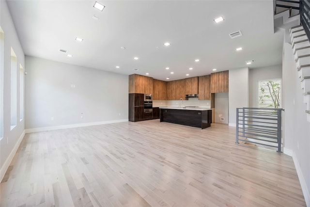 1111 W 21st St, Houston, TX 77008 - kitchen with light countertops, modern cabinets, open floor plan, light wood finished floors, and recessed lighting