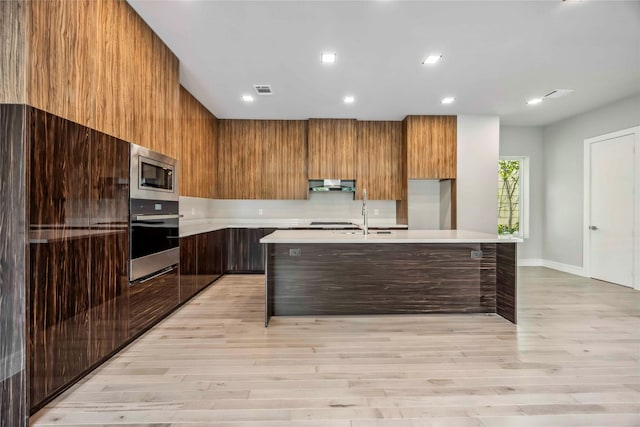 1111 W 21st St, Houston, TX 77008 - kitchen featuring appliances with stainless steel finishes, modern cabinets, light countertops, and recessed lighting