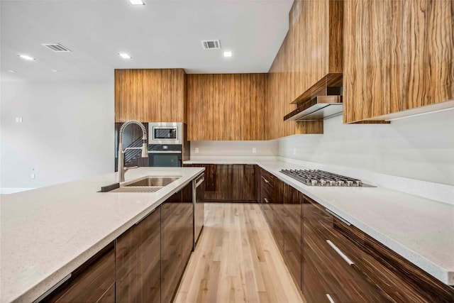 1111 W 21st St, Houston, TX 77008 - kitchen featuring appliances with stainless steel finishes, modern cabinets, light wood-style floors, and recessed lighting