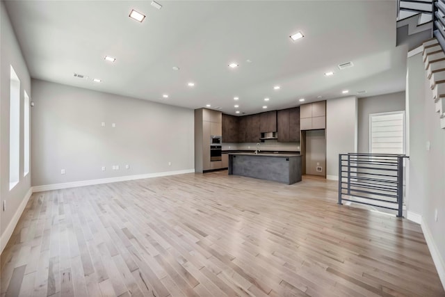 1111 W 21st St, Houston, TX 77008 - unfurnished living room with recessed lighting and light wood-type flooring