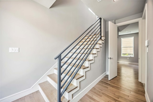 1111 W 21st St, Houston, TX 77008 - staircase featuring wood finished floors and baseboards