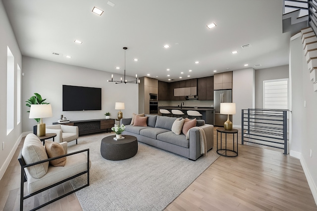 1111 W 21st St, Houston, TX 77008 - living area with light wood-type flooring, a chandelier, and recessed lighting
