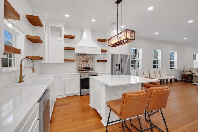 630 S Railroad Ave, Shepherd, TX 77371 - kitchen featuring open shelves, stainless steel appliances, premium range hood, recessed lighting, and decorative backsplash