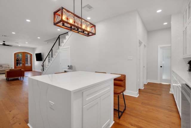 630 S Railroad Ave, Shepherd, TX 77371 - kitchen featuring recessed lighting, white cabinetry, light wood finished floors, decorative light fixtures, and a center island