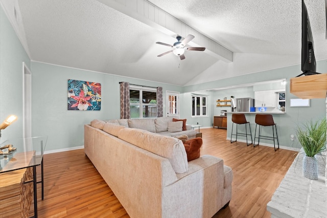 2014 17th St N, Texas City, TX 77590 - living room featuring light wood-style flooring, a ceiling fan, and a textured ceiling
