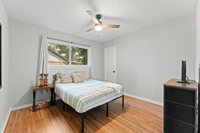 2014 17th St N, Texas City, TX 77590 - bedroom featuring light wood-type flooring, a textured ceiling, and a ceiling fan