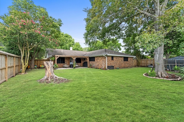 2014 17th St N, Texas City, TX 77590 - back of property with a fenced backyard, brick siding, a patio area, and a chimney