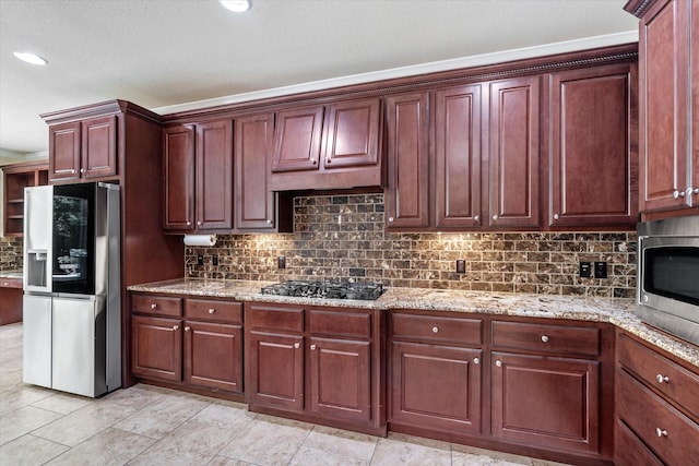 15602 Shining Brook Ct, Houston, TX 77044 - kitchen with stainless steel appliances, tasteful backsplash, light stone counters, and reddish brown cabinets