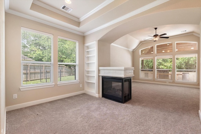 15602 Shining Brook Ct, Houston, TX 77044 - unfurnished living room featuring a multi sided fireplace, healthy amount of natural light, ornamental molding, a ceiling fan, and carpet flooring
