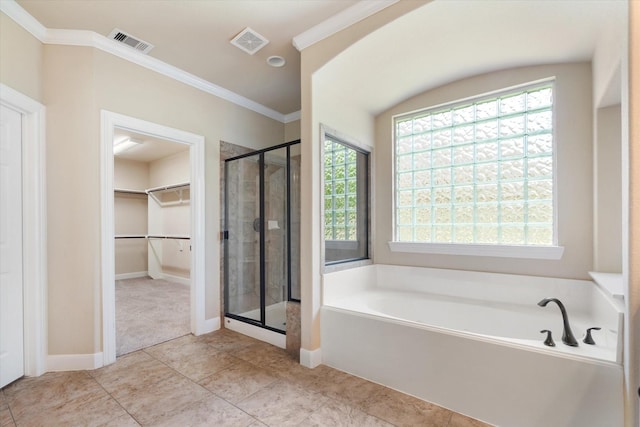 15602 Shining Brook Ct, Houston, TX 77044 - bathroom featuring a stall shower, a garden tub, crown molding, a spacious closet, and tile patterned flooring