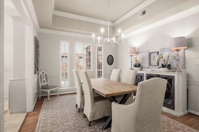 13306 Golden Valley Dr, Cypress, TX 77429 - dining space featuring wood finished floors, a chandelier, ornamental molding, and a tray ceiling