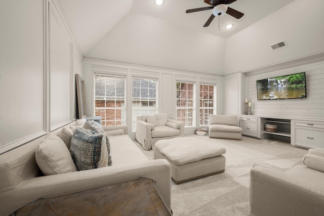 13306 Golden Valley Dr, Cypress, TX 77429 - living area with light carpet, ceiling fan, high vaulted ceiling, and a decorative wall