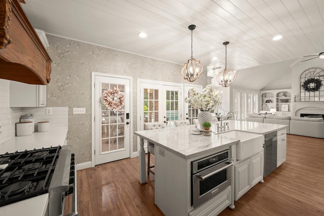 13306 Golden Valley Dr, Cypress, TX 77429 - kitchen featuring stainless steel appliances, wood finished floors, open floor plan, a chandelier, and french doors