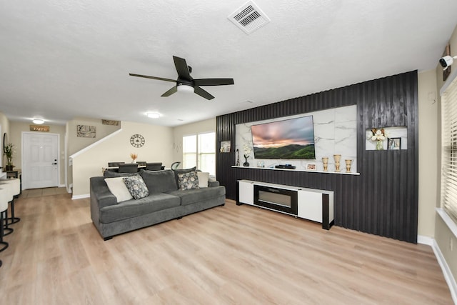 19110 Remington Springs Dr, Houston, TX 77073 - living area featuring a ceiling fan, wood finished floors, and an accent wall