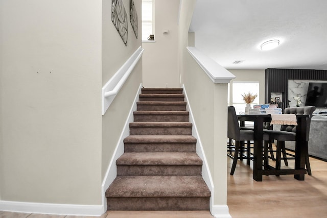 19110 Remington Springs Dr, Houston, TX 77073 - stairway with healthy amount of natural light and wood finished floors