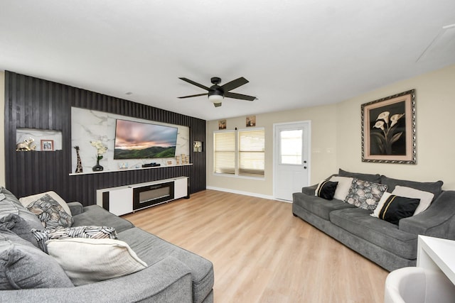 19110 Remington Springs Dr, Houston, TX 77073 - living room with ceiling fan, an accent wall, and wood finished floors
