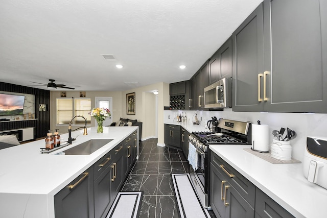 19110 Remington Springs Dr, Houston, TX 77073 - kitchen with appliances with stainless steel finishes, dark marble finish flooring, light countertops, recessed lighting, and a ceiling fan
