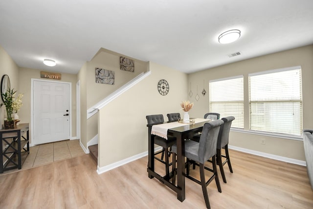 19110 Remington Springs Dr, Houston, TX 77073 - dining area with stairs and light wood-style floors