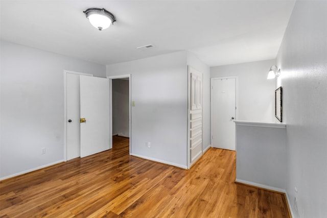 14333 Memorial Dr Unit 44, Houston, TX 77079 - unfurnished bedroom featuring light wood finished floors and baseboards