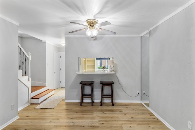 14333 Memorial Dr Unit 44, Houston, TX 77079 - spare room featuring a ceiling fan, stairs, wood finished floors, and crown molding