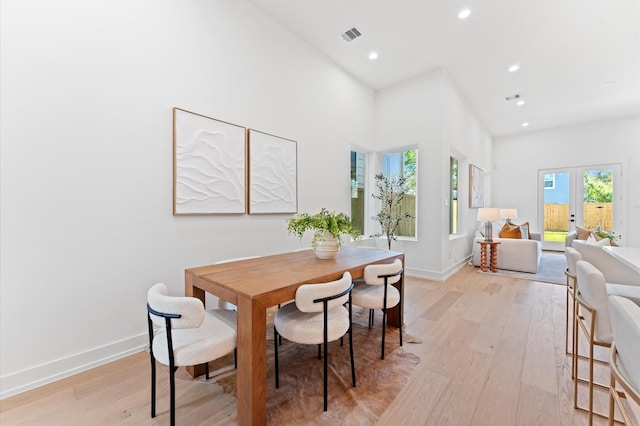 324 Aurora St, Houston, TX 77008 - dining room featuring light wood-type flooring, french doors, recessed lighting, and a towering ceiling