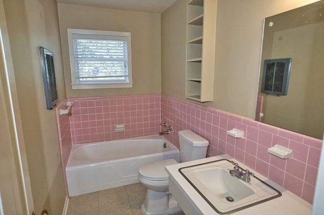 524 Oak Dr, Lake Jackson, TX 77566 - full bathroom with tile patterned floors, a garden tub, tile walls, and wainscoting