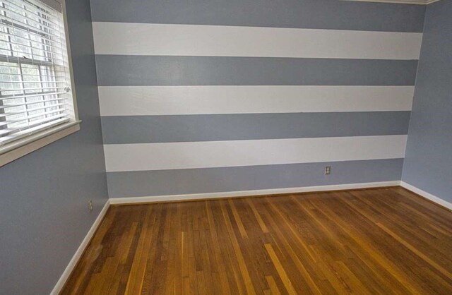 524 Oak Dr, Lake Jackson, TX 77566 - unfurnished room with wood finished floors and baseboards