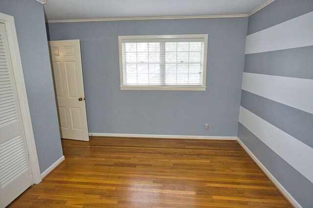 524 Oak Dr, Lake Jackson, TX 77566 - spare room with wood finished floors and crown molding