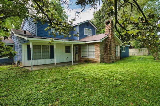 524 Oak Dr, Lake Jackson, TX 77566 - view of front of home with a chimney, a patio area, board and batten siding, and roof with shingles