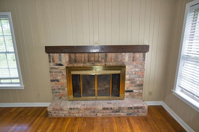524 Oak Dr, Lake Jackson, TX 77566 - detailed view of a brick fireplace, wood finished floors, and wooden walls