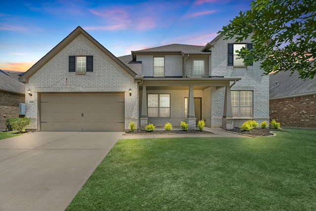 30212 Green Meadows Ln, Brookshire, TX 77423 - view of front facade with concrete driveway, a yard, covered porch, brick siding, and a garage