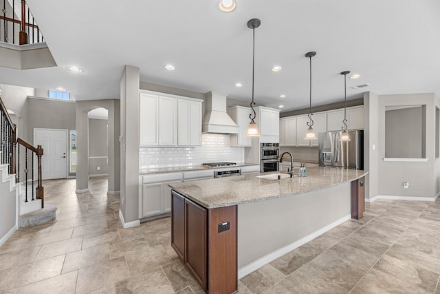 30212 Green Meadows Ln, Brookshire, TX 77423 - kitchen featuring appliances with stainless steel finishes, custom exhaust hood, backsplash, a large island, and white cabinetry