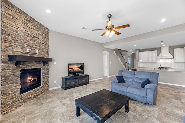 30212 Green Meadows Ln, Brookshire, TX 77423 - living area with stairway, ceiling fan, a stone fireplace, and recessed lighting
