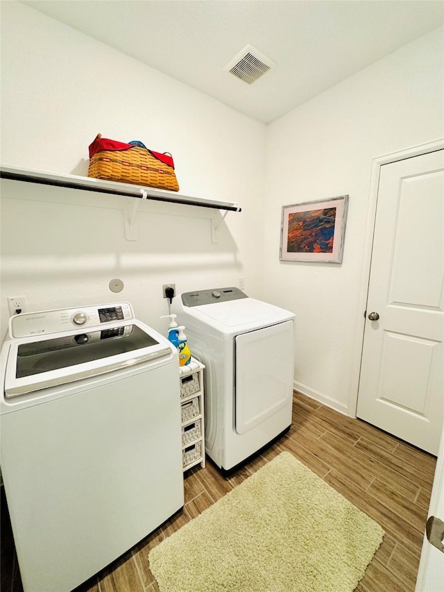 11119 Alpenhorn Pl, Tomball, TX 77375 - laundry area with independent washer and dryer and wood tiled floors