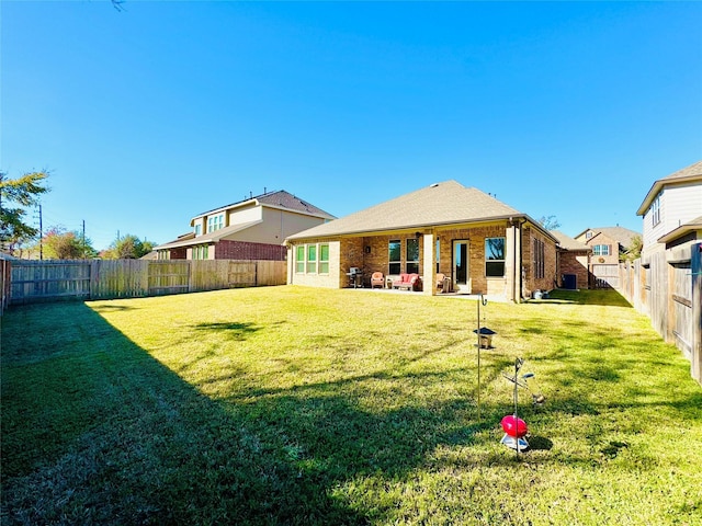 11119 Alpenhorn Pl, Tomball, TX 77375 - back of property with a fenced backyard, brick siding, and a patio
