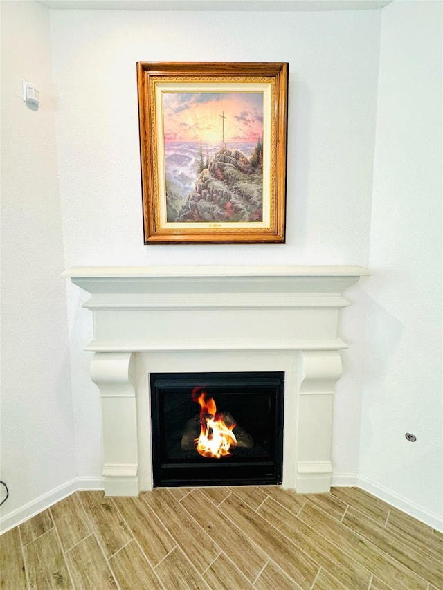 11119 Alpenhorn Pl, Tomball, TX 77375 - detailed view of a warm lit fireplace and wood finish floors