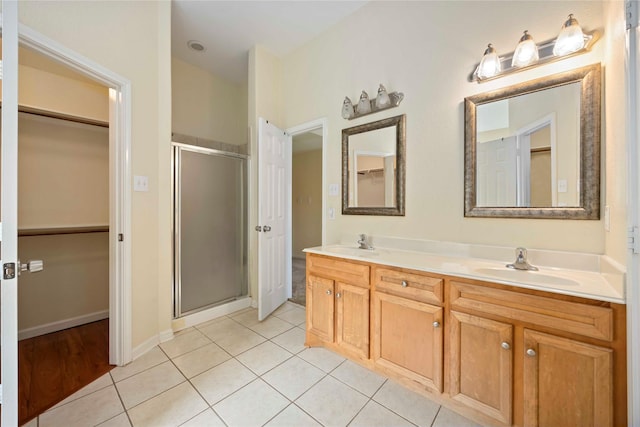 3722 Kildare Dr, Houston, TX 77047 - full bath featuring a stall shower, a spacious closet, double vanity, and tile patterned flooring