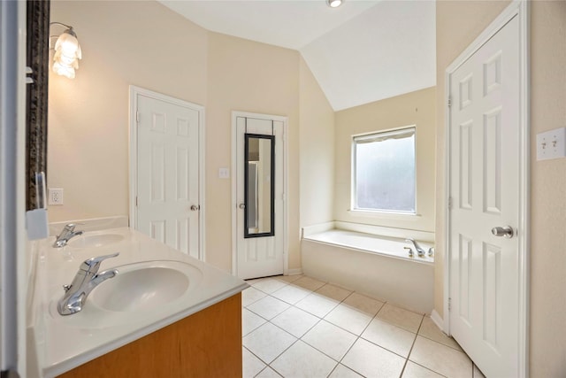 3722 Kildare Dr, Houston, TX 77047 - bathroom with tile patterned floors, double vanity, vaulted ceiling, and a garden tub