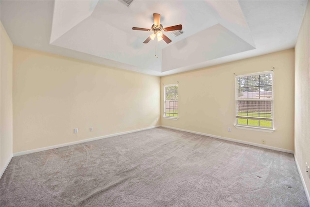 3722 Kildare Dr, Houston, TX 77047 - carpeted spare room featuring a tray ceiling, healthy amount of natural light, and a ceiling fan