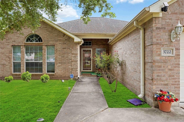 3722 Kildare Dr, Houston, TX 77047 - entrance to property featuring a yard, brick siding, and a shingled roof