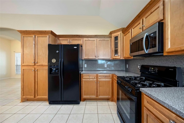 3722 Kildare Dr, Houston, TX 77047 - kitchen featuring black appliances, light tile patterned flooring, lofted ceiling, decorative backsplash, and arched walkways