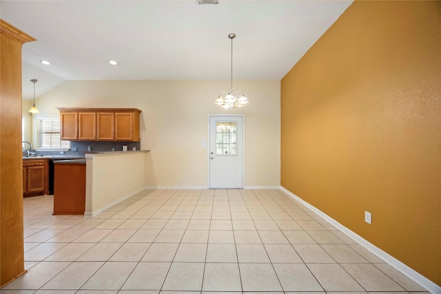 3722 Kildare Dr, Houston, TX 77047 - kitchen with vaulted ceiling, a chandelier, pendant lighting, brown cabinetry, and a peninsula