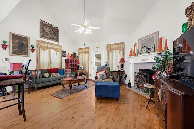 16535 Mccormick Dr, Houston, TX 77095 - living area with a ceiling fan, high vaulted ceiling, light wood-style floors, and a tile fireplace