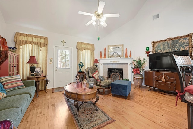 16535 Mccormick Dr, Houston, TX 77095 - living area with vaulted ceiling, a ceiling fan, wood finished floors, and a tile fireplace